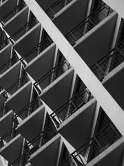 A series of triangular balconies forming a repeating pattern, in black and white.
